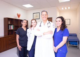 Group of diverse healthcare professionals in a clinical setting, showcasing teamwork and care.